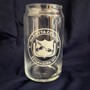 16 oz clear glass in the shape of a can. The Marietta College Faux Seal is printed in white on the front